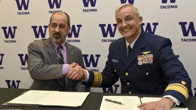 Rear Adm. Jack Vogt, commander, 13th Coast Guard District, shakes hands with Mark A. Pagano, chancellor, University of Washington Tacoma