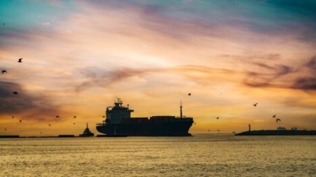 Ship and tug at twilight