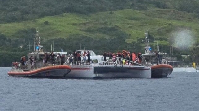 USCG boat crews evacuate a catamaran