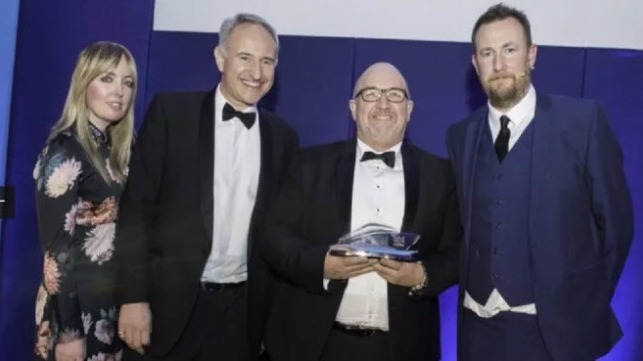 Fred. Olsen Cruise Lines? Mike Evans, Head of Sales (2nd from right), receives the award from comedian and host, Alex Horne (far right), with Cruise Trade News? Rebecca Barnes and Andrew Say (2nd from left). [Photo: Steve Dunlop]