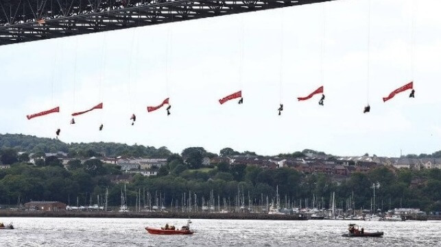 protestors hanging from Scottish bridge