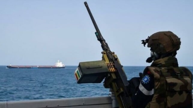 warship escorting merchant ship in the Red Sea