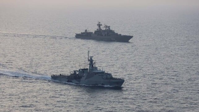 HMS Trent (foreground) escorts Vice Admiral Kulakov (Royal Navy)