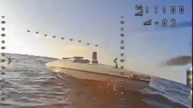 A remotely-controlled FPV drone approaches what appears to be a Ukrainian unmanned attack drone boat (Telegram via Status-6)