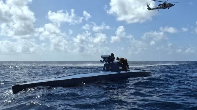 A Coast Guard boarding team searches the semisub, March 22 (USN)