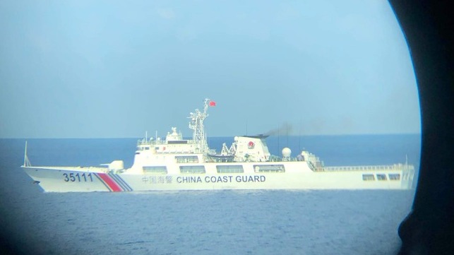 China Coast Guard cutter seen through a porthole