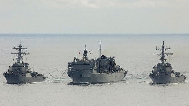 The U.S. Navy guided-missile destroyers USS Porter, left, and USS Donald Cook, right, replenish from the fast combat support ship USNS Supply.