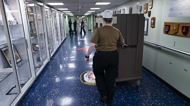 Hospitalman Rhiannon O'Malley transports patient meals to the intensive care unit aboard the Military Sealift Command hospital ship USNS Comfort.