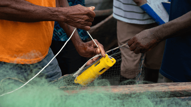 A fisher attaching a temperature and depth sensor to his fishing net in Ghana (Ocean Data Network, Environmental Defense Fund, Partnership for Observation of the Global Ocean, and the University of Ghana)