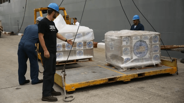 Civilian mariners with Military Sealift Command unload an aid cargo in Thailand (USN file image)