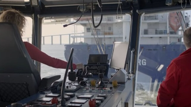 Female seafarer on tug bridge
