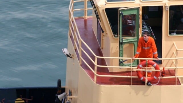 Seafarer on the bridge deck of a tug