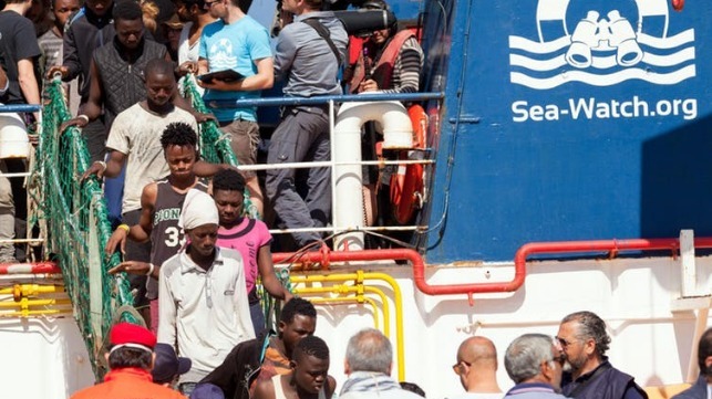 People rescued at sea disembark from the Sea-Watch in early June 2018 at the Italian port of Reggio Calabria. Marco Costantino/EPA