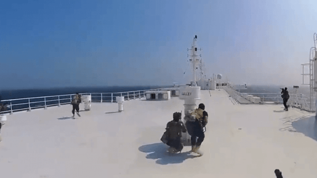 Houthi fighters advance along the top deck of the Galaxy Leader (Houthi Military Media)