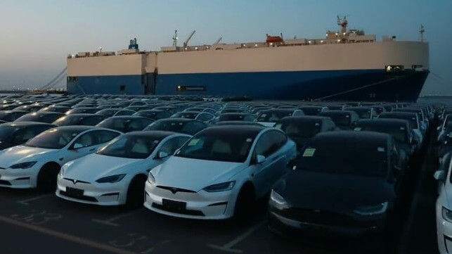 cars on dock with car carrier