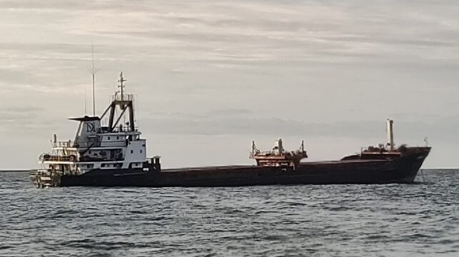 cargo ship low at the stern