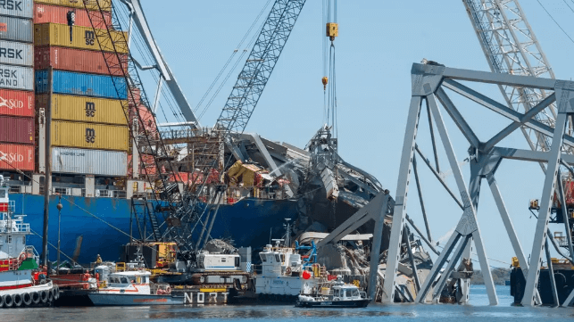 Salvors use a diamond wire-cutting rig to remove bridge wreckage from Dali's starboard side, April 25 (USACE)