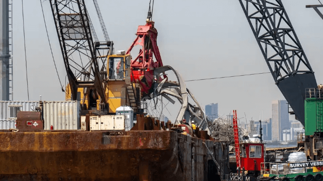 Contractors use a bucket dredge to lift wreckage of the Key Bridge, April 2024 (USACE)