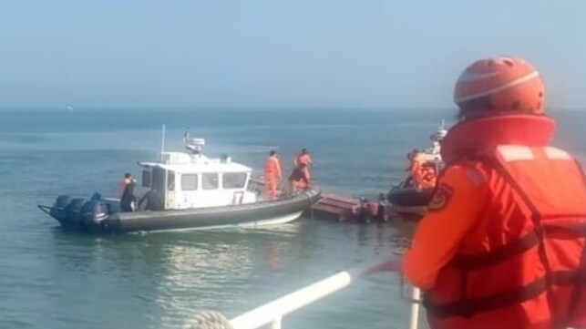 Taiwan Coast Guard Administration personnel inspect the capsized Chinese speedboat (CGA handout)
