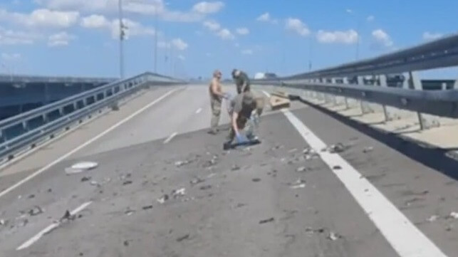 Russian soldiers collect debris from the scene of the blast (Russian Ministry of Defense)