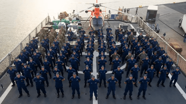 Crew of USCGC Waesche on the back deck with pallets of drugs