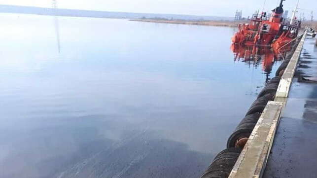 Dredger Ginger partially submerged at pier in Mykolaiv