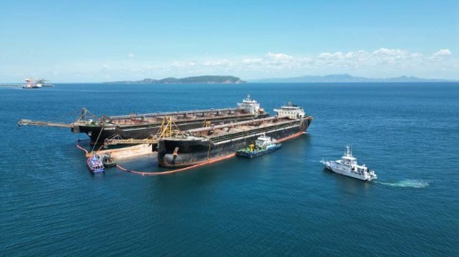 capsized dredger with two other dredgers and response boats