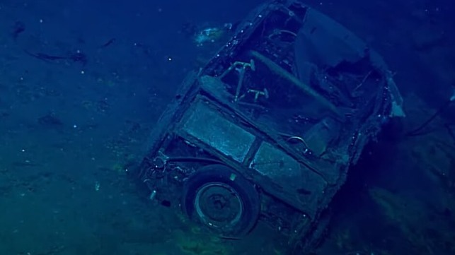A small flash of chrome can be seen on the jeep's rear bumper, left of the spare tire (NOAA)