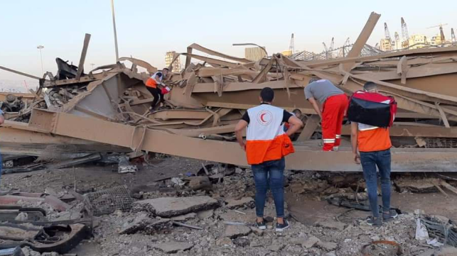 wreckage in beirut with search team